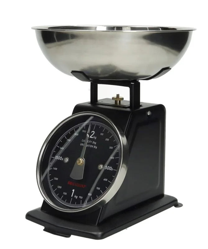 Balanza de cocina vintage en color negro, con dial y base decorativa.