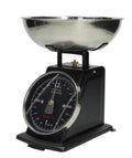 Balanza de cocina vintage en color negro, con dial y base decorativa.