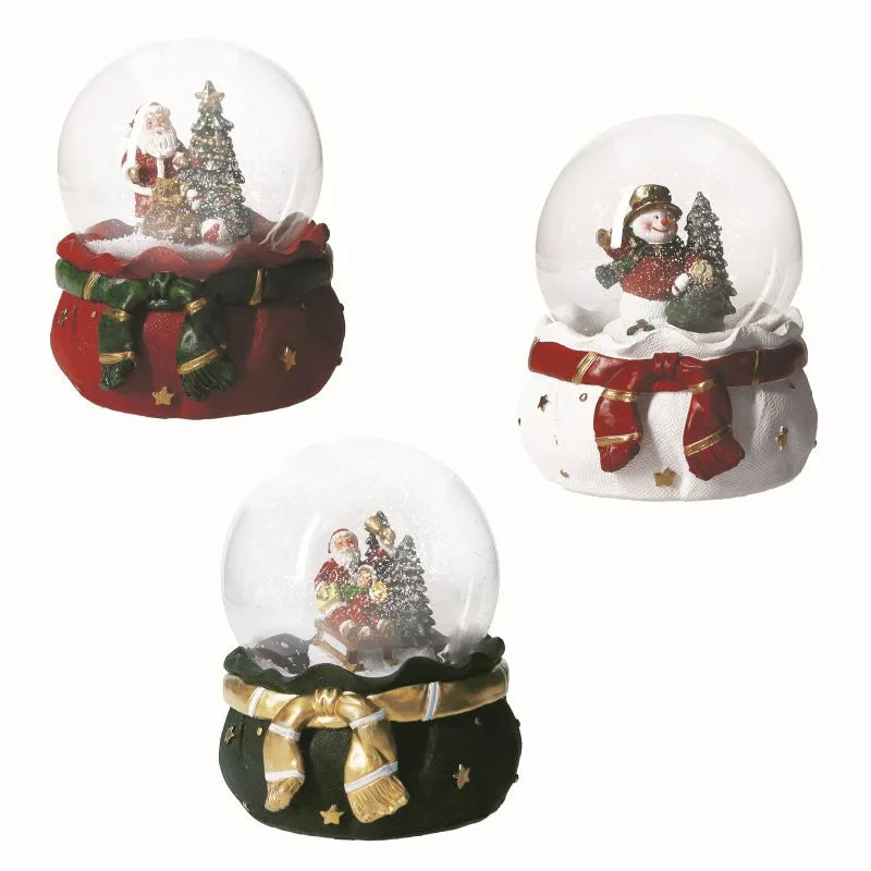 Carrillón decorativo tipo bola de nieve con base y detalles festivos, marca Brandani Gift Group.