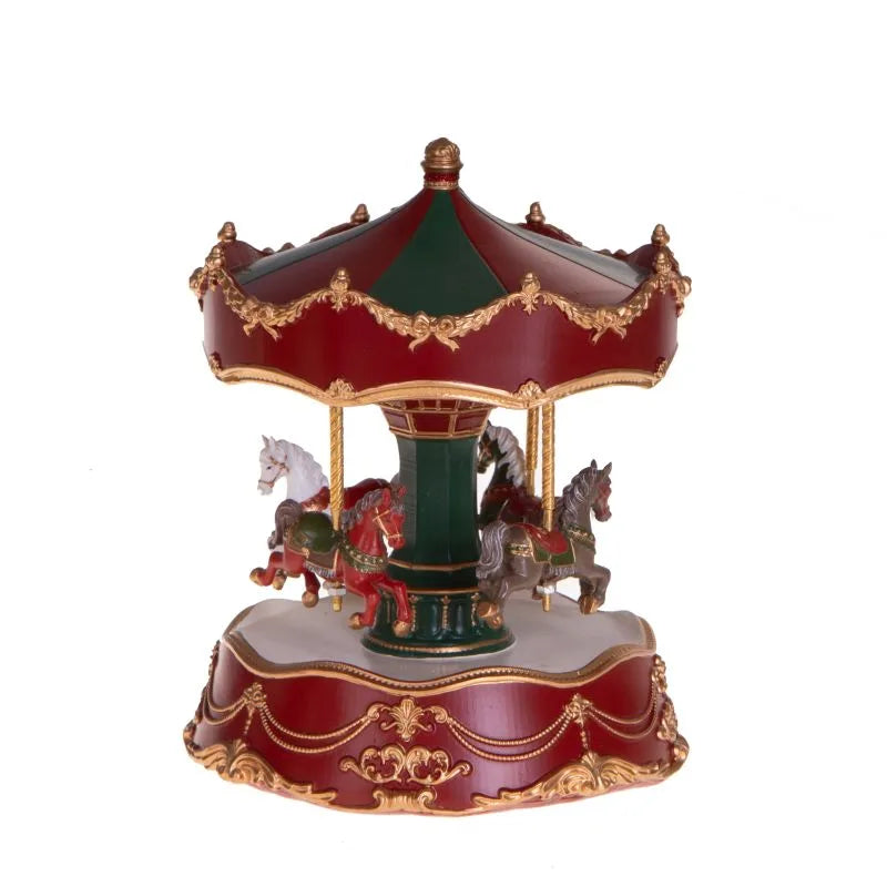 Carrillón tiovivo musical navideño con base decorativa y figura giratoria.