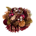 Corona navideña de 15 cm con piñas y bolas decorativas sobre un fondo neutro.
