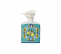 Difusor de fragancia Citrus Azul con tapa y varillas, sobre fondo blanco.