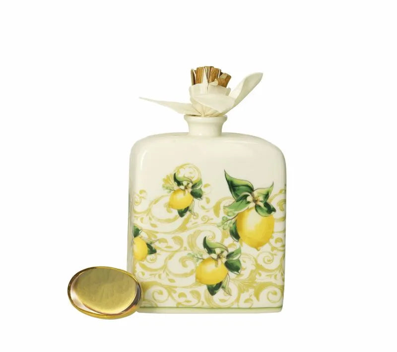 Difusor de fragancia Limoni en porcelana blanca con detalles de limones y hojas verdes.