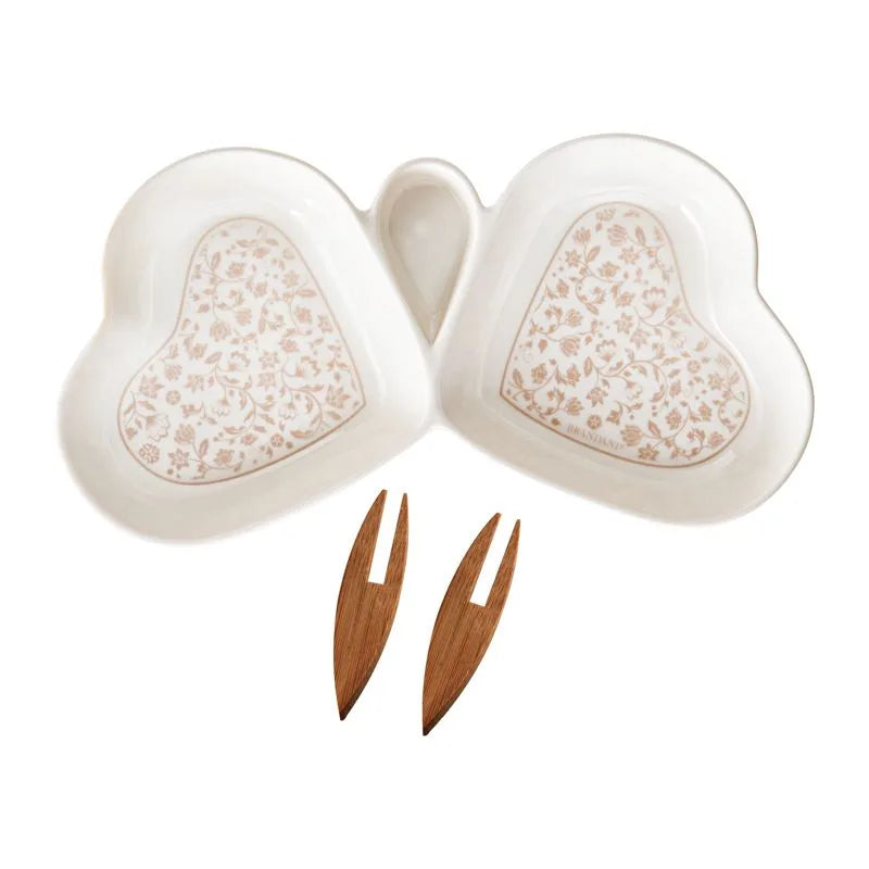 Entremesera redonda de porcelana blanca con motivos florales Campo Ai Fiori, junto a dos tenedores de bambú.