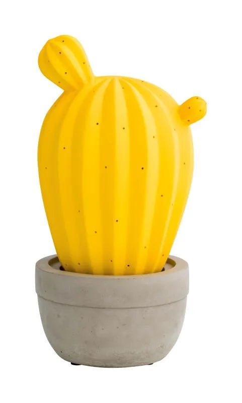Lámpara de sobremesa con forma de cactus, fabricada en porcelana amarilla, sobre un fondo neutro.