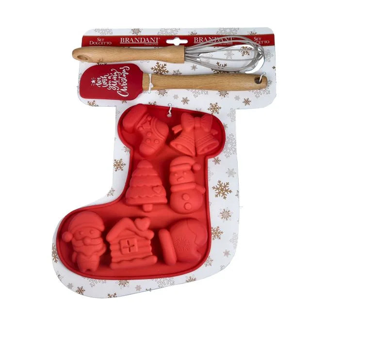 Molde para galletas navideñas de color rojo con forma de bolsa, acompañado de una batidora y una espátula de silicona.