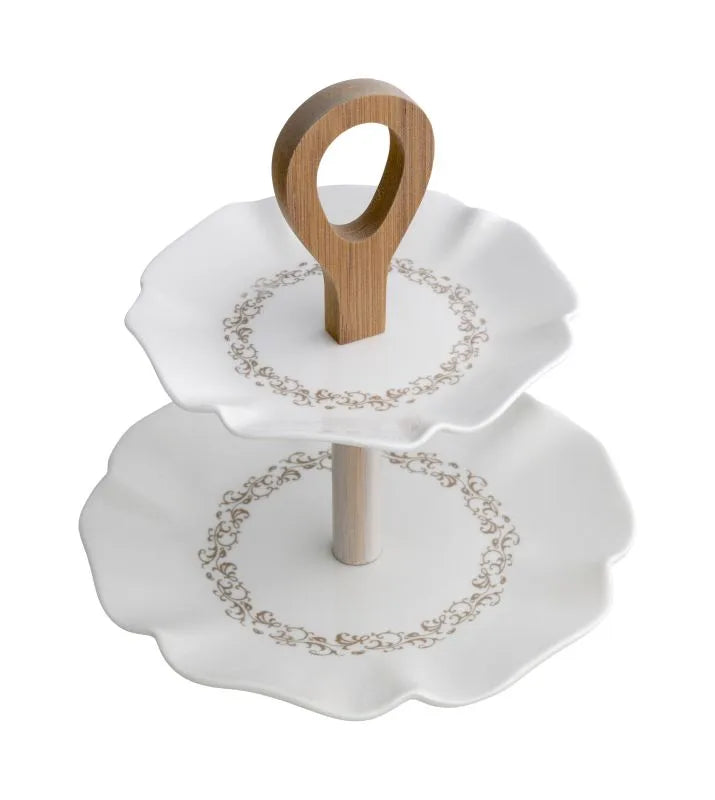 Plato de tarta con pie de porcelana, colección Rizos de Hada, con un diseño delicado y curvo.