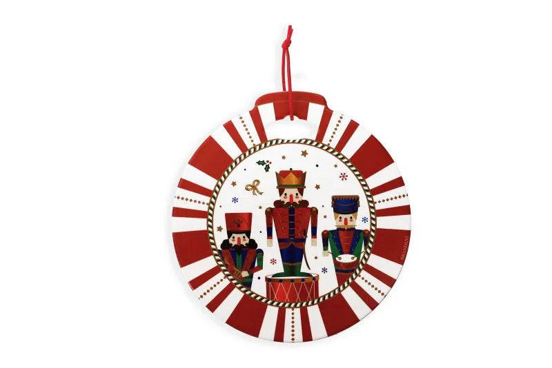 Salvamanteles redondo de cerámica blanca con diseño de 'El Cascanueces' y borde rojo, combinado con base de corcho.