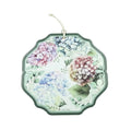 Salvamanteles Flora de Brandani con un patrón floral sobre fondo blanco.