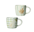 Set de 2 tazas de cerámica con diseño de calabaza y hoja de uva en tonos cálidos.