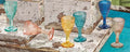 Set de 6 copas de chupito en colores surtidos variados sobre fondo blanco.