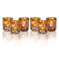 Set de 6 vasos de cristal de color ámbar, modelo Pavone, presentados juntos.