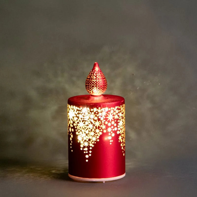Vela navideña rotatoria roja con luz LED, con detalles decorativos y base circular.